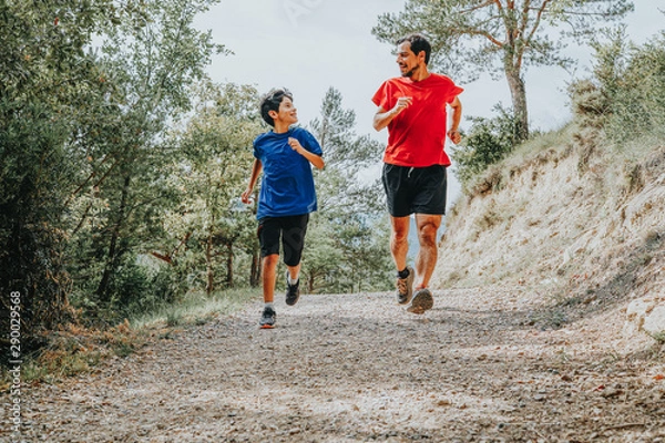 Obraz father and son running in the mountain