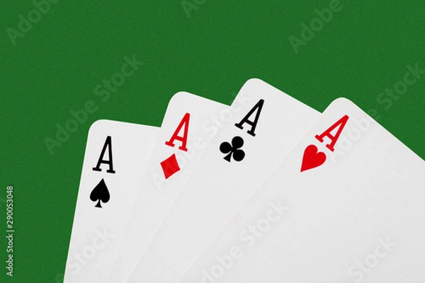 Fototapeta close up on a poker of aces isolated on green table with  copy space for your text