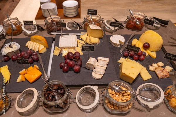 Fototapeta Assortment of cheese and nuts for breakfast at luxury hotel