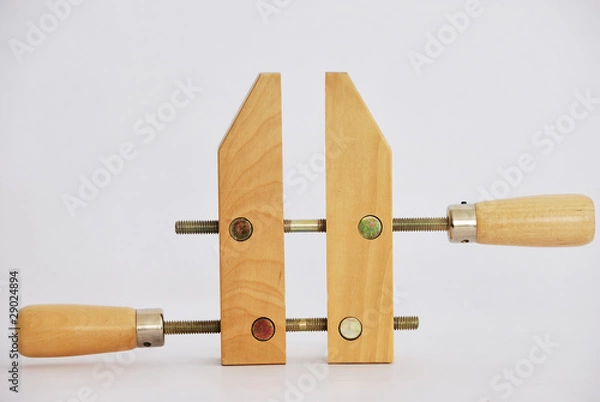 Obraz Old-fashioned wooden clamp isolated on white background