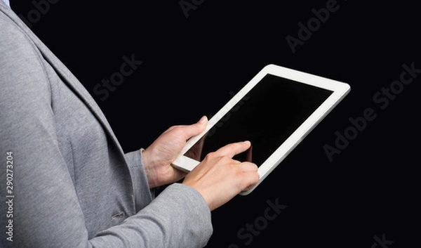 Fototapeta Unrecognizable Businesswoman Using Tablet On Black Studio Background, Mockup