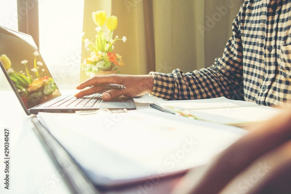 Fototapeta Business man working sitting at desktop computer at his desk in modern bright startup office.