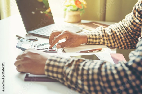 Fototapeta Businessman Calculating Invoice using Calculator In The Office.