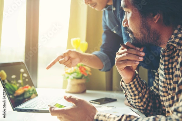 Fototapeta Business meeting time. Photo young account managers crew working with new startup project. Notebook on white table. Idea presentation, analyze plans.