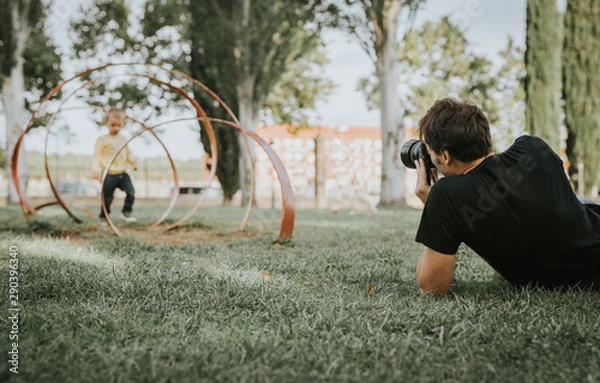 Fototapeta photographer or videographer working in the park.