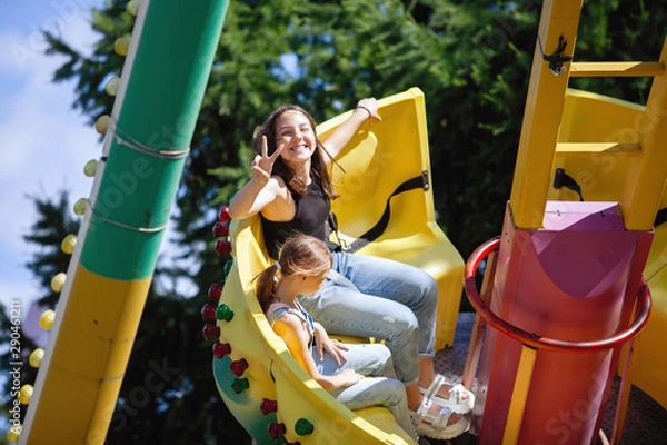 Fototapeta Yellow carousel in a summer city park.