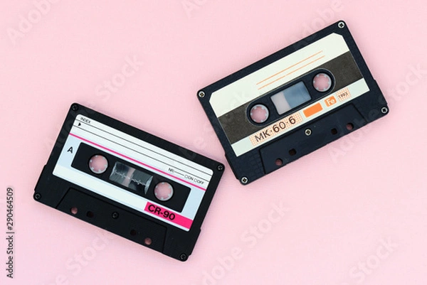 Fototapeta Old audio tape cassettes on a pink background. Top view, old technology concept