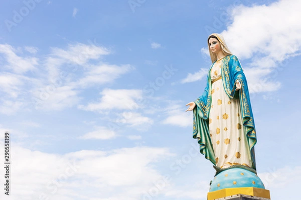 Obraz The Blessed Virgin Mary,mother of Jesus on the blue sky, in front of the Roman Catholic Diocese, public place in Chanthaburi, Thailand.