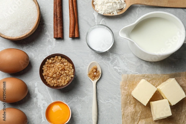 Fototapeta Flat lay composition with fresh ingredients for delicious homemade cake on light grey marble table