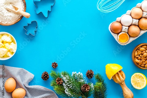 Fototapeta Cooking for Christmas or New Year dinner. Ingredients and utensil on blue background top view space for text