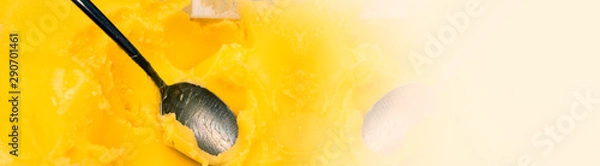 Fototapeta Closeup of ghee butter - famous cooking ingredient, element of bulletproof diet. Wide panoramic half banner image. Copy space. 