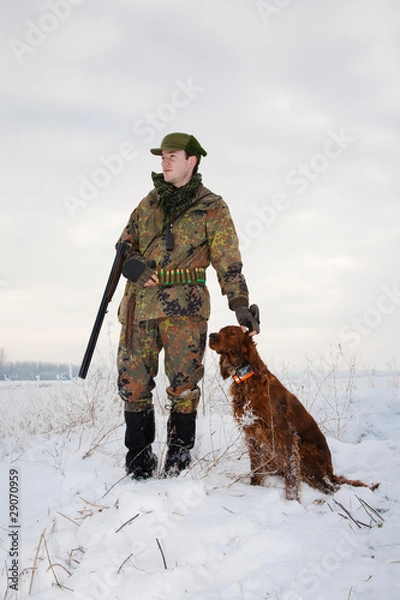 Fototapeta Hunter and his hunting dog waiting for the hunt to begin