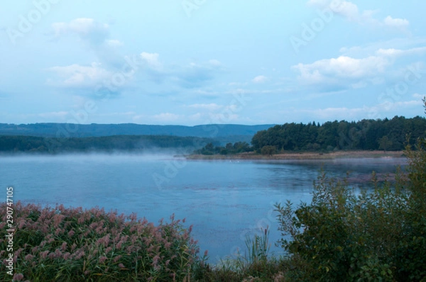 Fototapeta colorful moon on autumn lake at dawn with forest