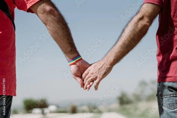Obraz Two gay men shake hands with an LGBT bracelet.LGTB,LGBT