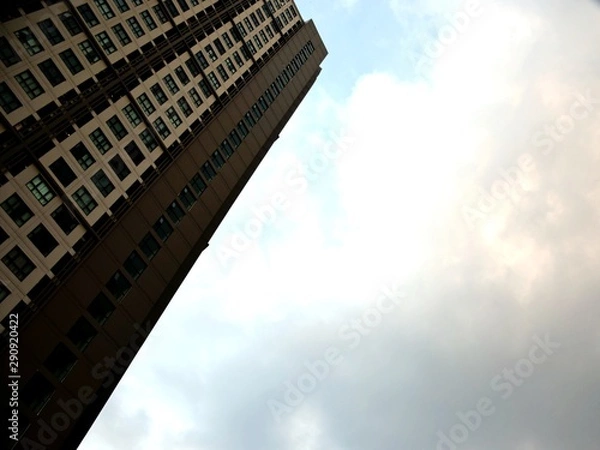 Fototapeta The tilted image of tall buildings and the sky after the rain clouds passed.