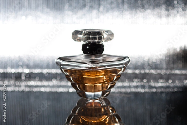 Obraz Perfume bottle with reflection on silver