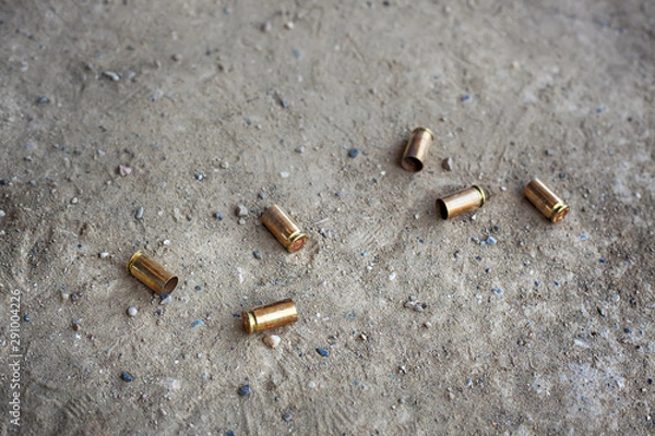 Fototapeta 9 mm bullet shells lying on the ground