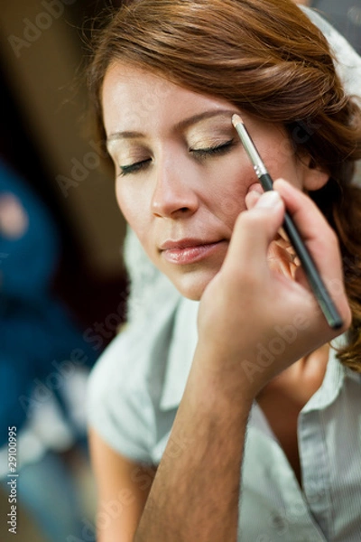 Obraz bride having a pro make up before wedding