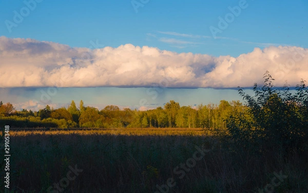 Fototapeta Landscape panorama before sunset with heavy clouds in the distance from which it rains, nature, view, summer, weather