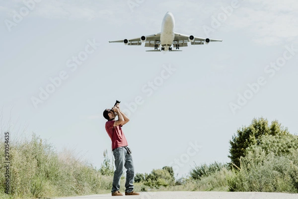 Obraz Photographer taking pictures of a very large plane