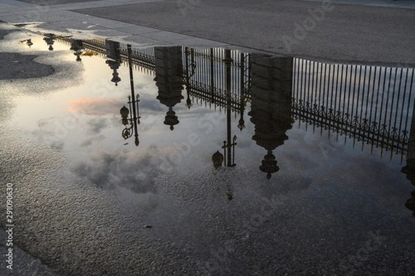 Fototapeta reflection of the Palacio Real, in Madrid on a puddle of water on the street