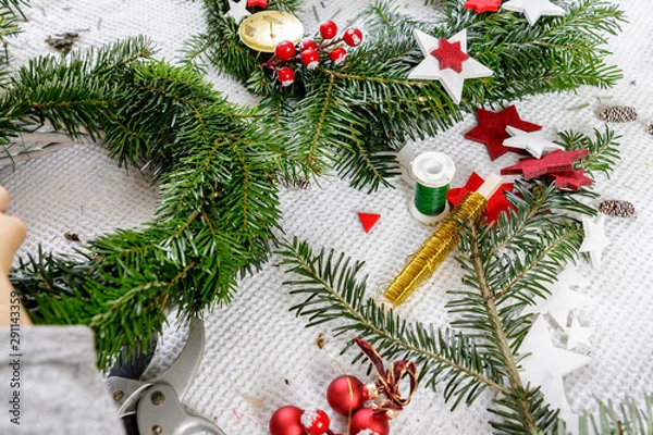 Fototapeta Decoration of handmade red and white advent christmas wreath from fir