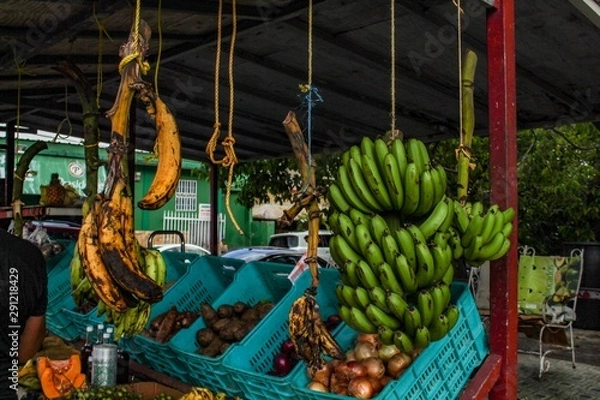 Fototapeta Fruit Stand in San Juan Puerto Rico with a variety of fresh produce for sale including plantains, mangoes and bananas