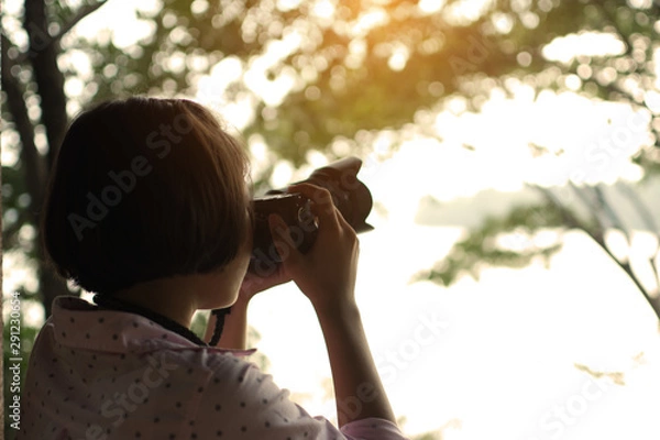 Obraz Asian girl shooting picture in the park traveling on holiday.
