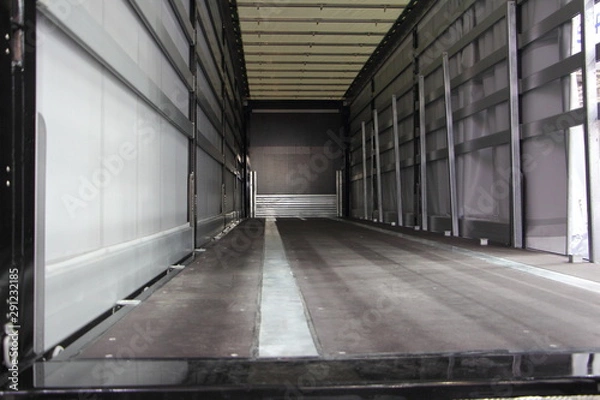 Fototapeta New truck empty semi trailer inside rear view close-up, lorry transportation logistics