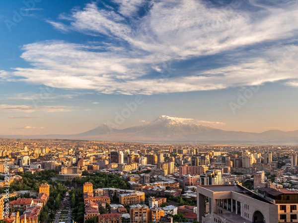 Fototapeta Yerevan city at sunset seen from the top of Cascade with magnificent Mount Ararat in the background.