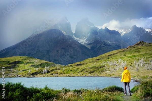 Fototapeta Active girl enjoy the view on amazing mountain landscape with Los Cuernos rocks and Lake Pehoe in Torres del Paine national park duting hiking in the mountains, Patagonia. Chile