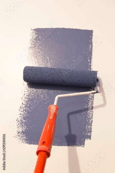 Obraz Decorator's hand painting wall with roller