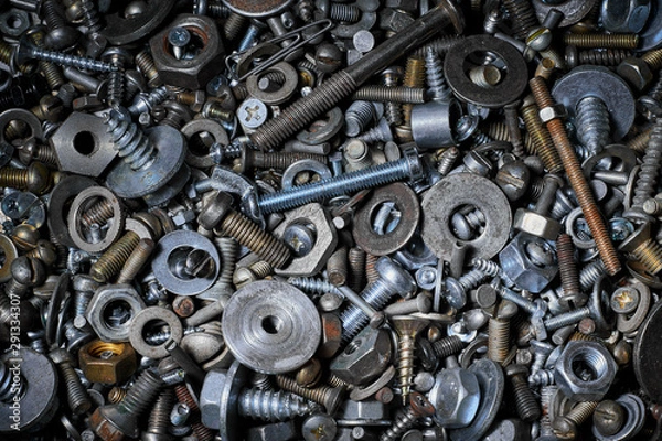 Fototapeta Abstract background with various screws, nuts, bolts and washers and other fasteners. Macro.