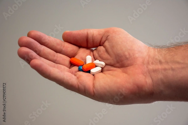 Obraz Hand holding pills