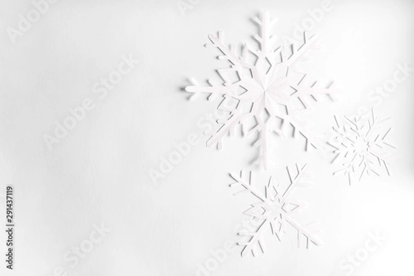 Fototapeta white background with paper snowflakes