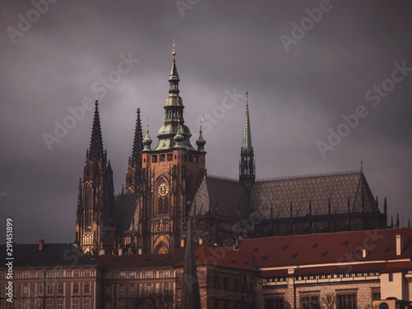 Fototapeta View of St. Vitus Cathedral, under a dark sky.