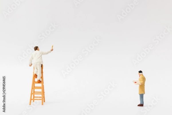 Fototapeta Miniature people : Painter holding a brush with  space for text