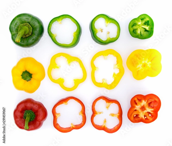 Fototapeta Set of sliced green yellow and red bell pepper section pieces isolated over white background, view above