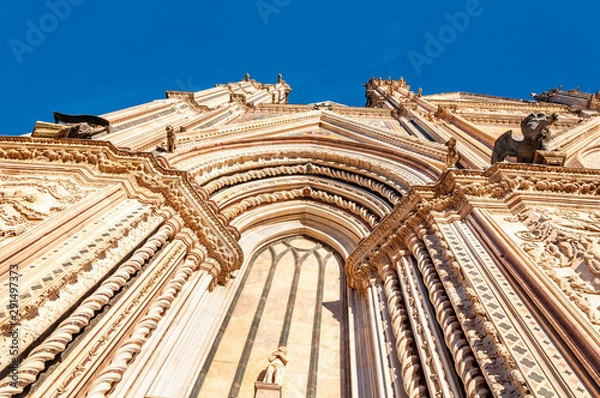 Obraz Orvieto, Italy. Perspective view of the Cathedral of "Santa Maria Assunta", a masterpiece of Gothic architecture. Decorated with spiers, cusps, bas-reliefs and stained glass windows.