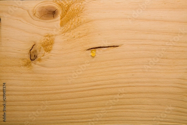 Fototapeta The resin flows over the treated wooden beam.