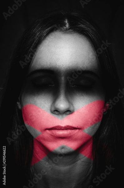 Fototapeta Female portrait with marks of blindness and silence. Concept of quiet victim of discrimination and woman who prefers not to look at face of problems