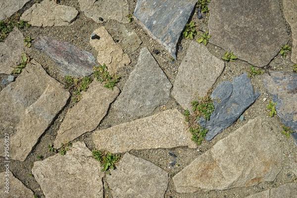 Fototapeta Background of stone-paved uneven track. Construction. Pieces of stone. Handwork.