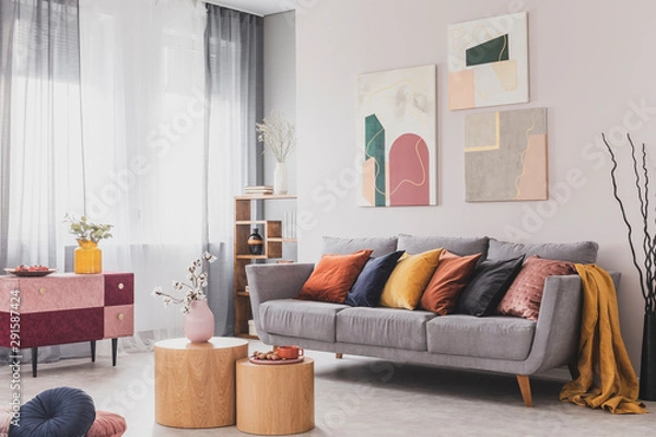 Fototapeta Coffee table in front of grey couch in scandinavian living room