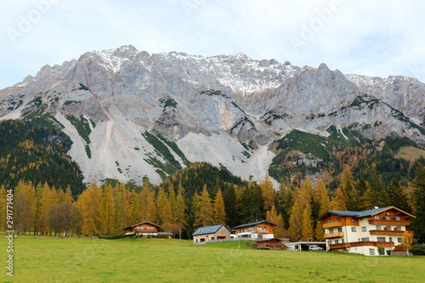 Fototapeta Autumn landscape with village at the foot of the alps mountains