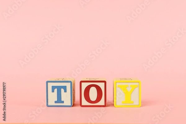 Fototapeta Colored cubes with letters with the inscription Toy on a pink background