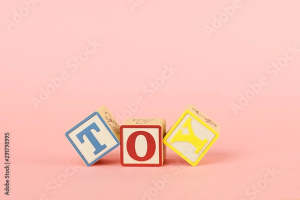 Fototapeta Colored cubes with letters with the inscription Toy on a pink background