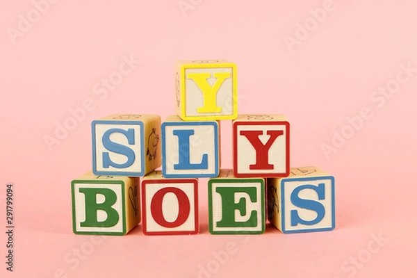 Fototapeta Toy colored cubes with letters on pink background