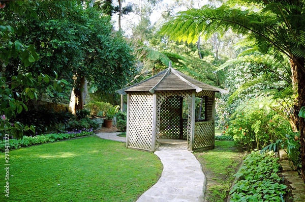 Fototapeta A pathway through a summerhouse and beyond.