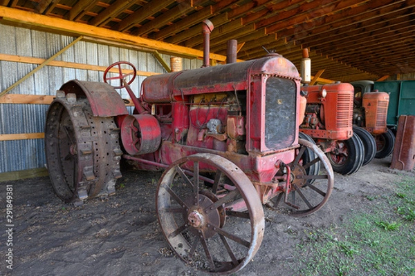 Obraz old farm tractor in a shed