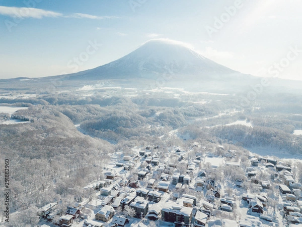 Obraz Winter in Niseko, Japan. A Blue bird kind of day at Grand Hirafu, Niseko Ski Resort. Photos were taken with a drone overlooking the Grand Hirafu area with views of Mt. Niseko-Annupuri. and Mt. Yotei.